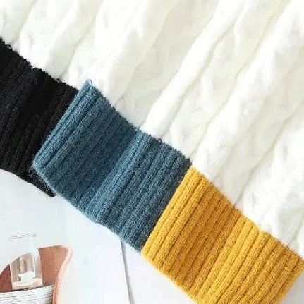 Colorful ribbed cuffs on a cozy Norway neck sweater.