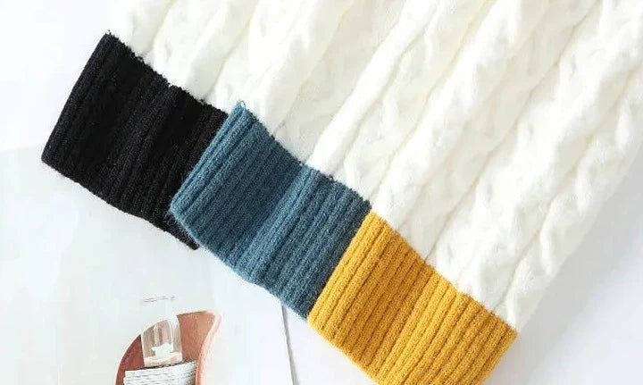 Colorful ribbed cuffs on a cozy Norway neck sweater.