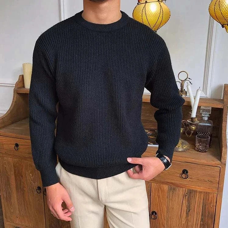 Antonios solid round neck knit sweater in black worn by a man, made from high-quality standard wool.