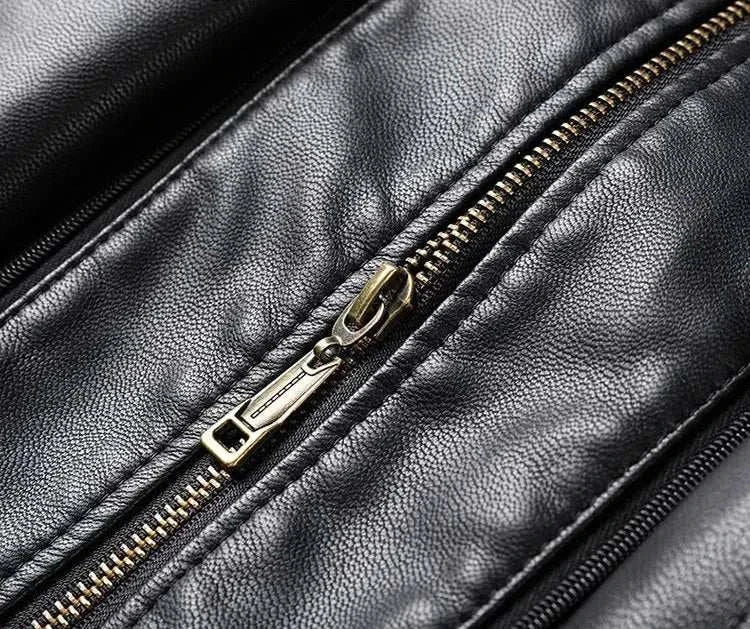 Close-up of black PU leather long coat with zipper detail.
