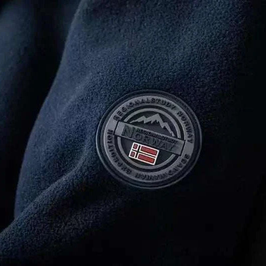Norway puffer jacket with emblem detail on sleeve, close-up view.