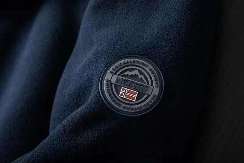 Norway puffer jacket with emblem detail on sleeve, close-up view.