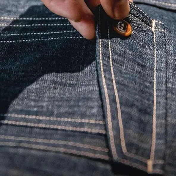 Close-up of RETRO denim solid long-sleeve shirt pocket detail.