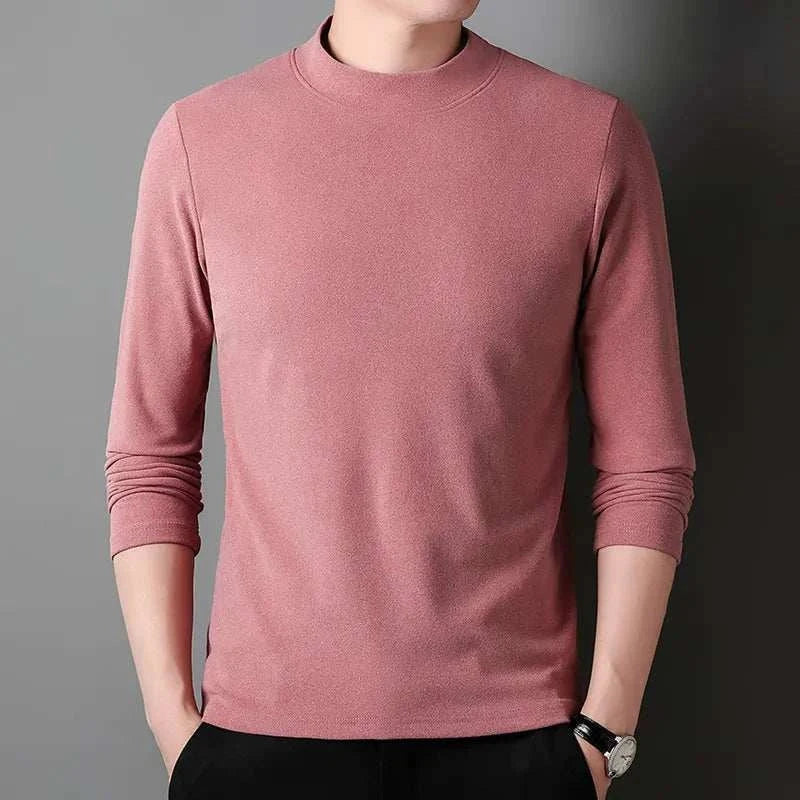 Classic turtleneck sweater in pink on male model.