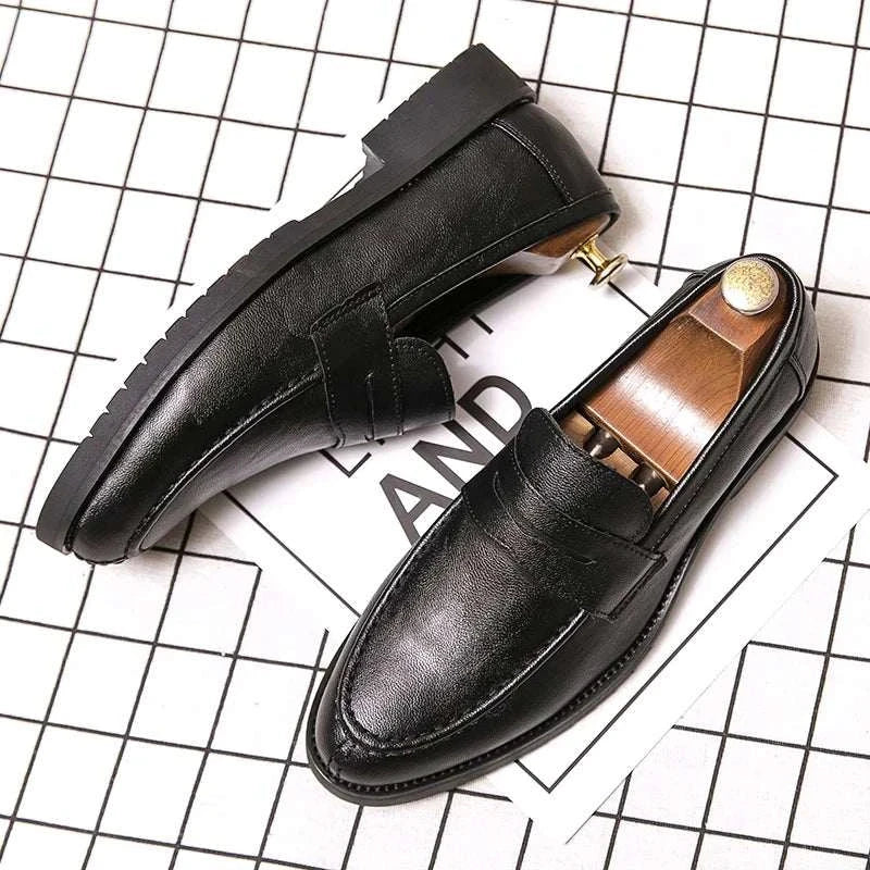 British casual loafers with rubber outsole on a grid background.