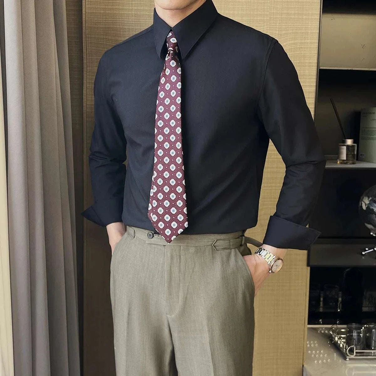 British formal slim-fit shirt in dark color, paired with patterned tie for men.