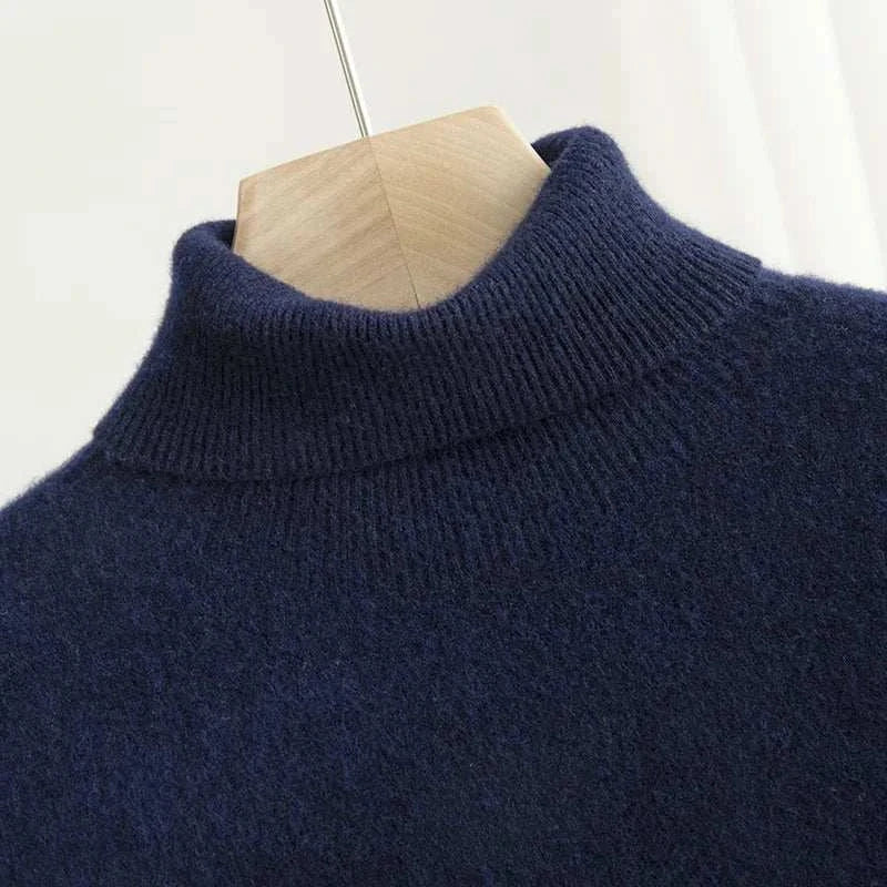 Business wool turtleneck sweater in navy blue on a hanger.