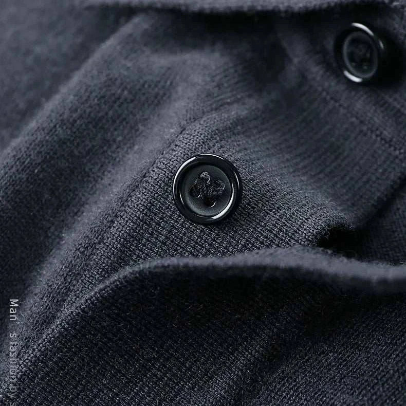 Close-up of black wool with buttons on Antonios wool polo sweater.