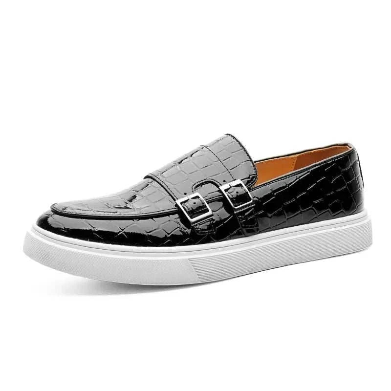 Monk double strap loafers in black with textured finish and white sole.