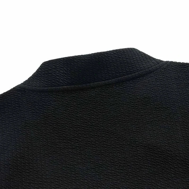 Close-up of black textured winter cardigan sweater with zipper.