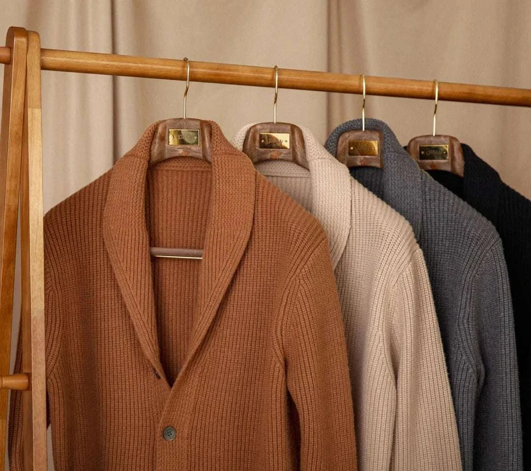 Autumn old money cardigan collection displayed on wooden hangers.