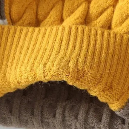 Brown and yellow Norway neck sweater fabric detail, showcasing cable knit and ribbed textures.