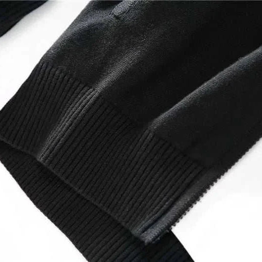 Cold season casual cardigan sleeve detail in black cotton fabric.