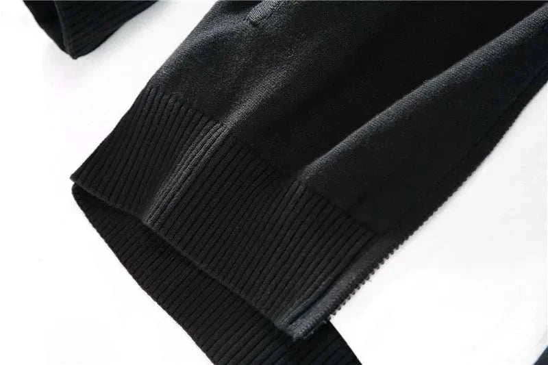 Cold season casual cardigan sleeve detail in black cotton fabric.