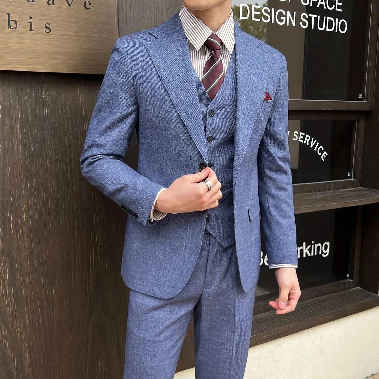 Groom wedding 3 piece suit in blue with vest and matching trousers.