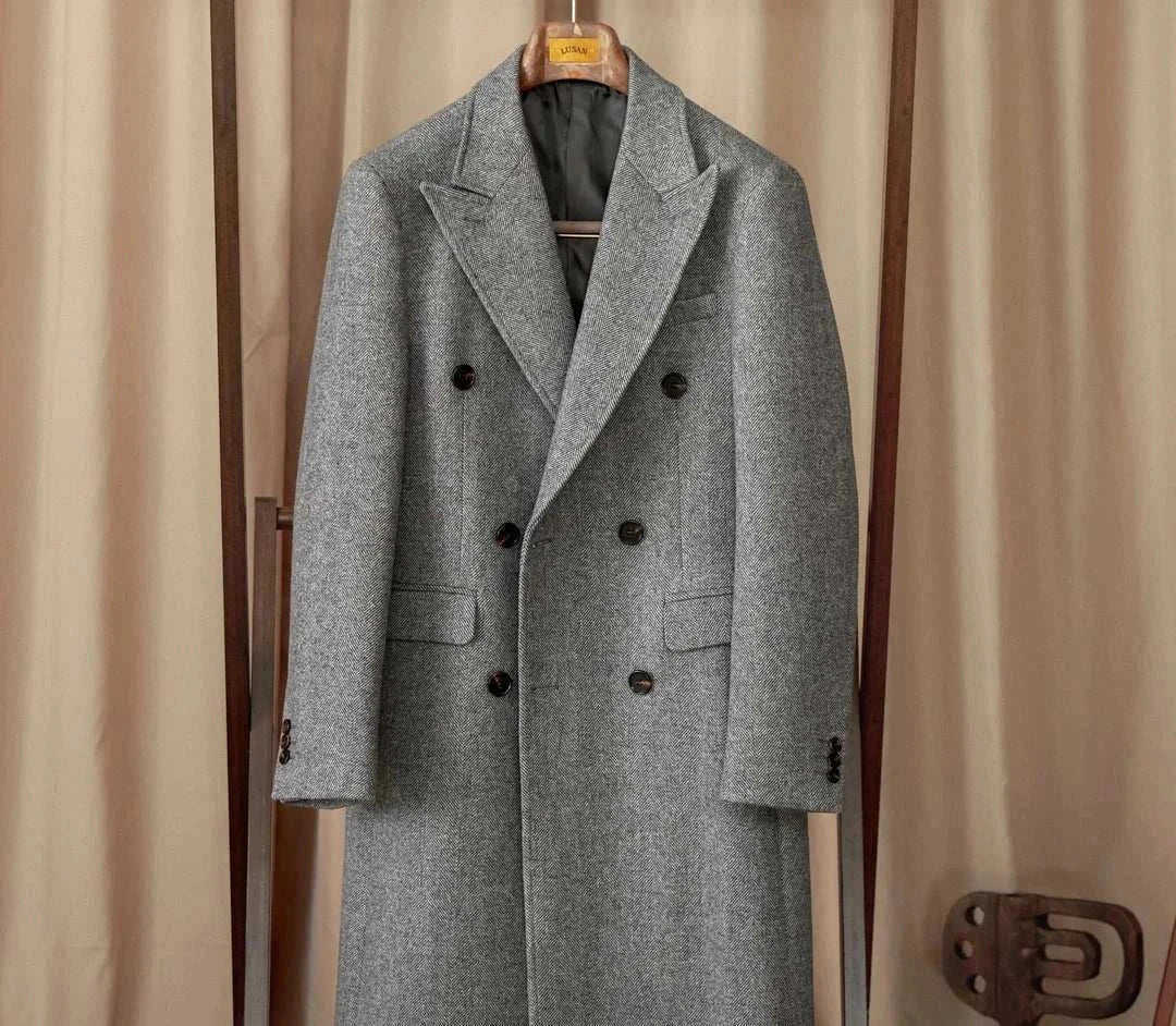 Men's winter double-breasted wool coat in gray, hanging on a wooden hanger.
