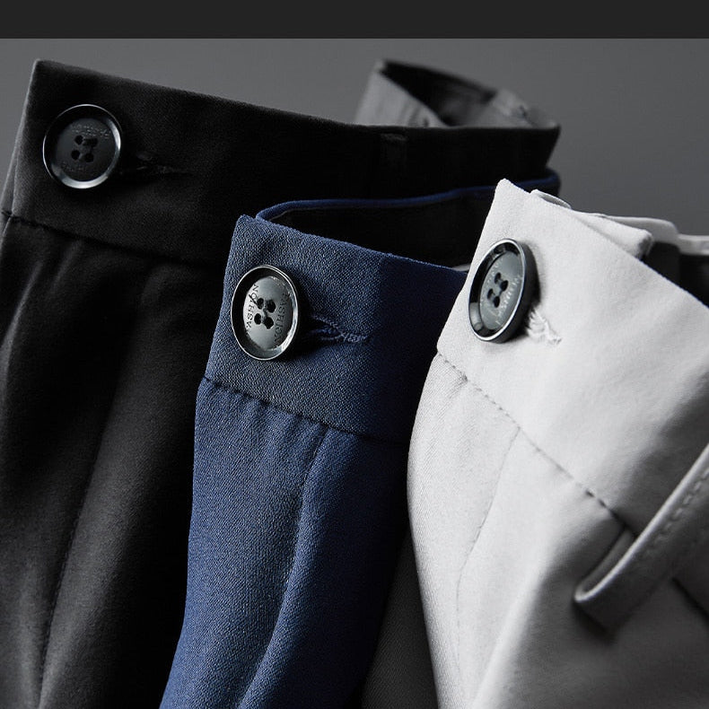 Close-up of Vinny Office Pants in black, navy, and gray, showcasing button details and refined tailoring.