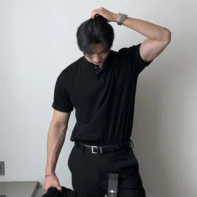 Man wearing a black Antonios smart casual summer t-shirt with classic collar in a stylish pose.