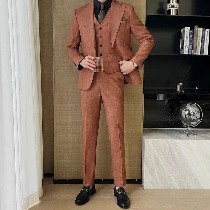 Groom in a stylish brown 3 piece wedding suit with a vest and tie, perfect for a confident look.