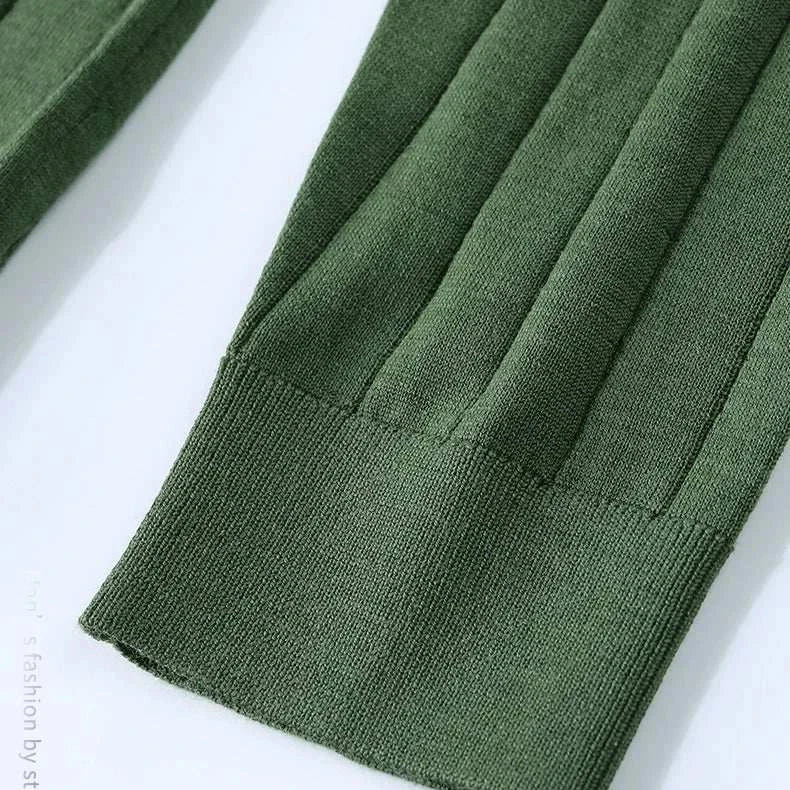 Green ribbed sleeve detail of casual wool autumn sweater.