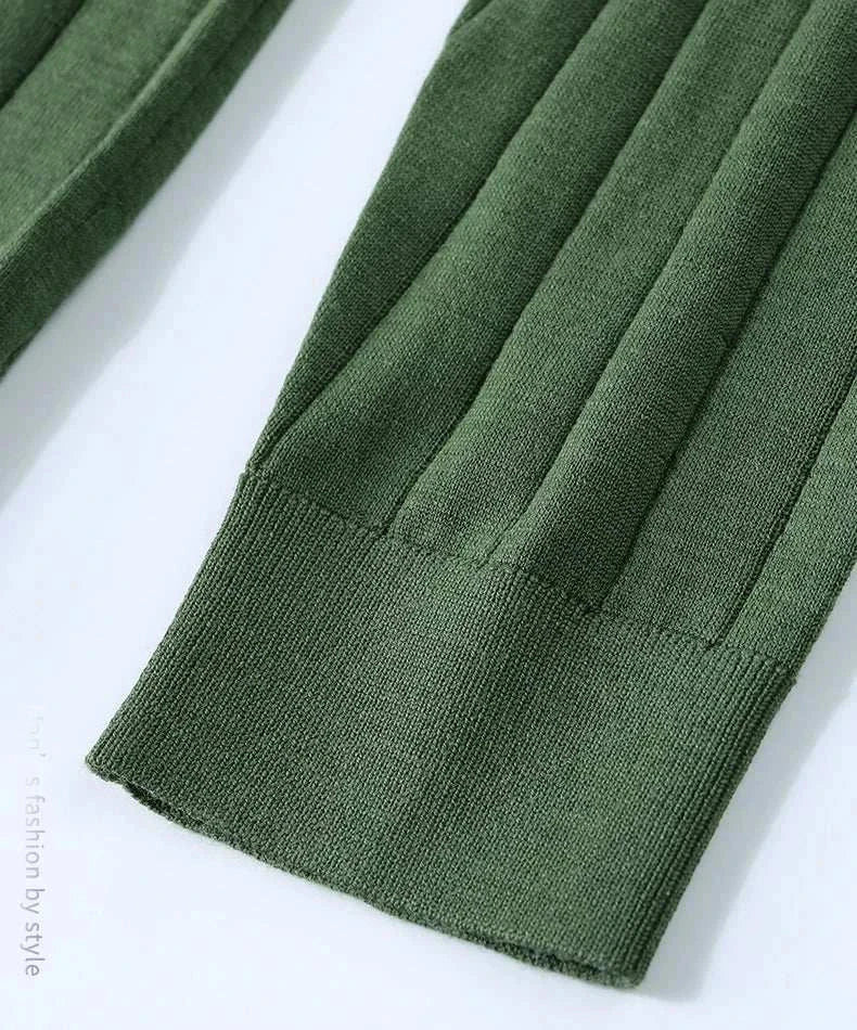 Green ribbed sleeve detail of casual wool autumn sweater.