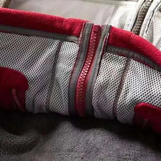Inner lining of Norway puffer jacket showing red and gray colors.