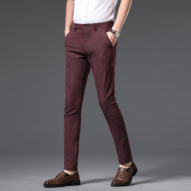 Man wearing Vinny Plaid Trousers in wine red, styled casually with brown loafers and a white shirt.