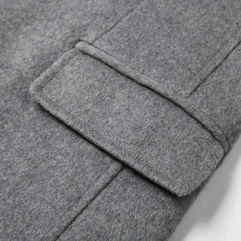Close-up of wool elegant long coat in gray polyester fabric.