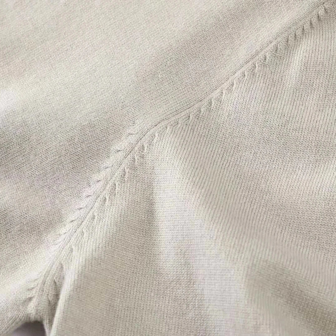Close-up of fabric detail of an autumn Korean premium sweater with buttons, showcasing fine stitching and wool texture.