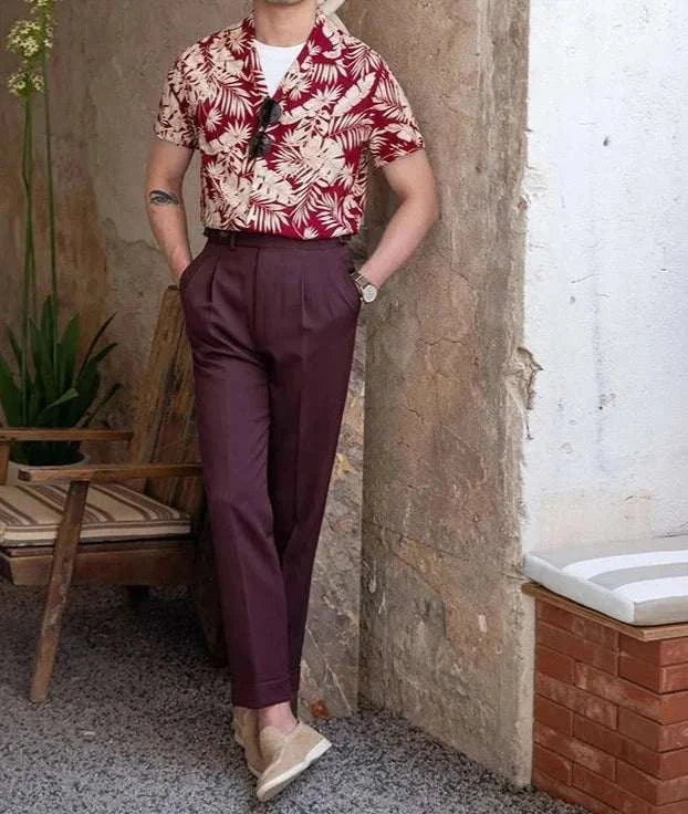 Vintage Hawaiian flower shirt with tropical design, worn by a man, styled casually with burgundy pants, perfect for summer/spring.