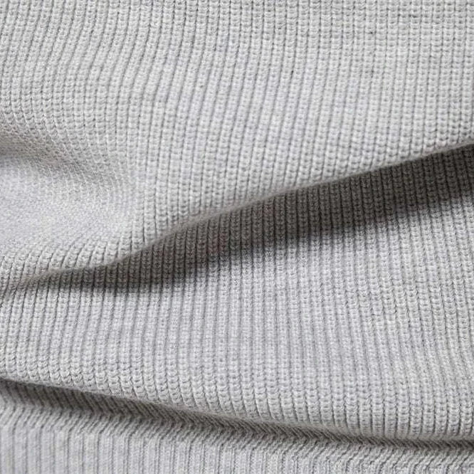 High-collar autumn/winter sweater fabric close-up showcasing ribbed knit texture in grey.