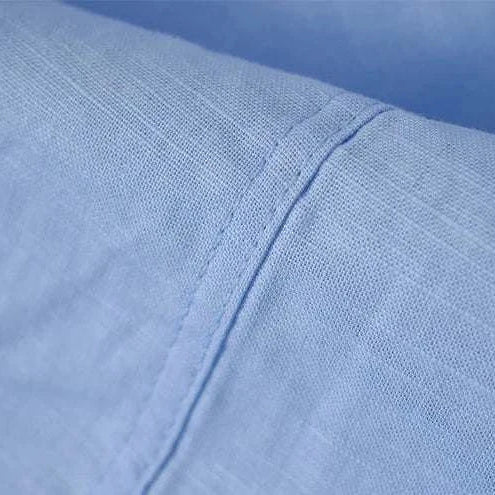 Close-up of Antonios blue cotton-linen long sleeve shirt fabric.