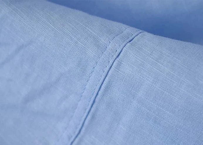 Close-up of Antonios blue cotton-linen long sleeve shirt fabric.