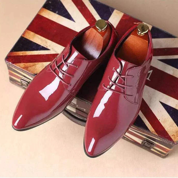 Burgundy Brogue elegant shoes for men on a Union Jack suitcase background.