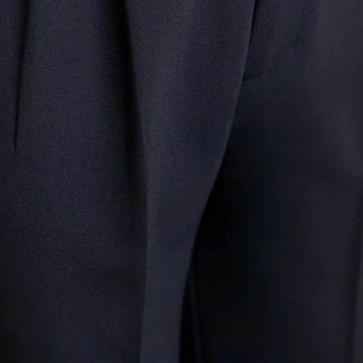 Antonios draped suit pants Korean-inspired elegance close-up showing fabric texture.