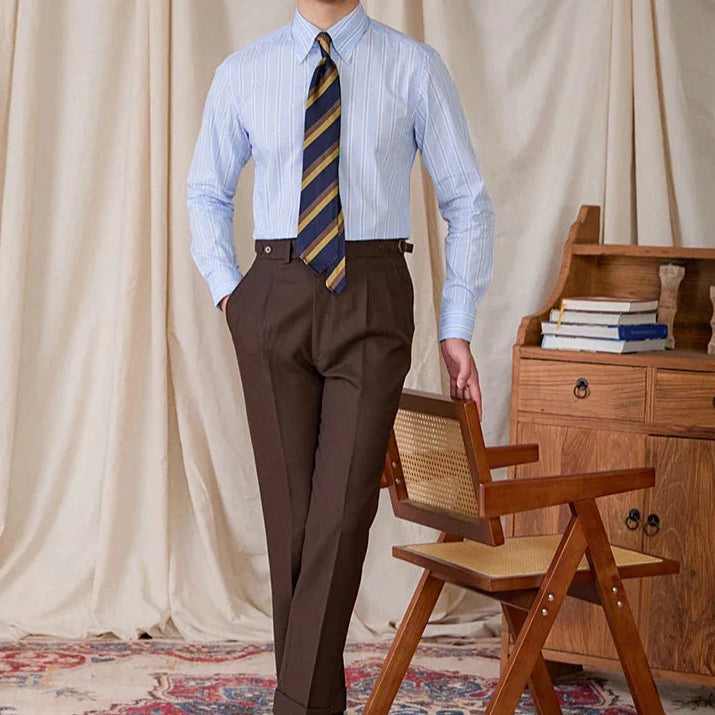 Men's business stripe all long sleeve shirt in blue with a tie, paired with brown trousers.