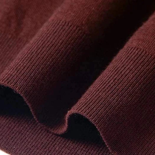 Slim fit wool autumn sweater in rich brown fabric close-up.