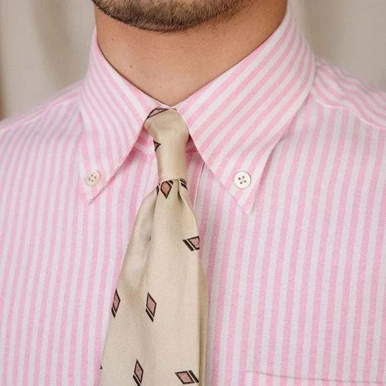 Oxford style casual cotton shirt with pink and white stripes and a beige patterned tie.