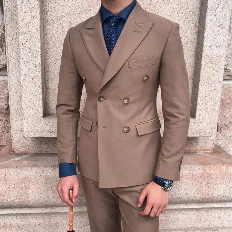 Elegant beige suit with double-breasted design, worn over a blue shirt and tie.