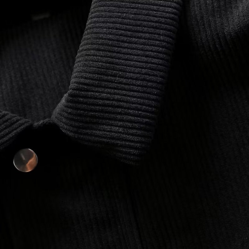 Close-up of black Corduroy casual jacket with button detail.