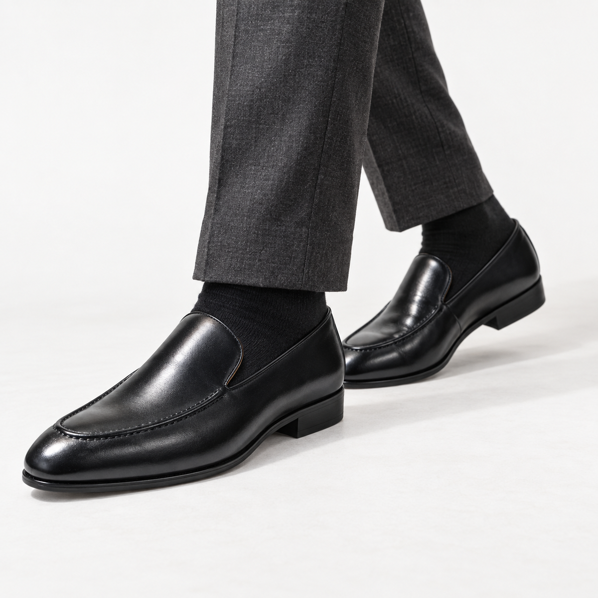 Leonardo pointed toe leather loafers in black, side worn view