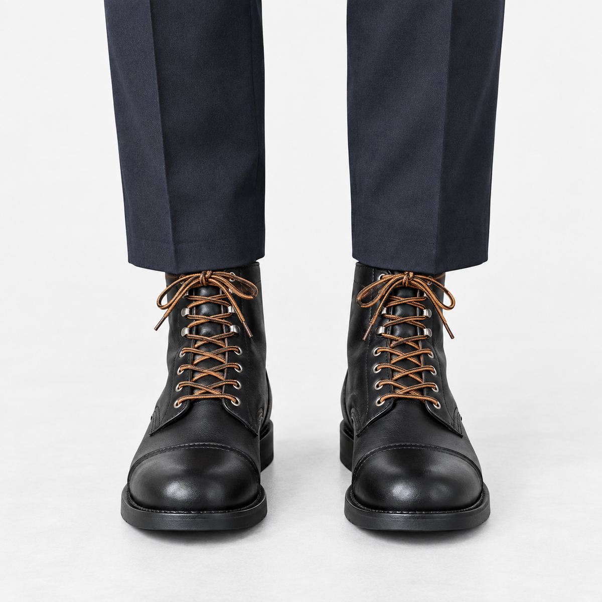 Leather cap toe lace up boots in black, front view on a model