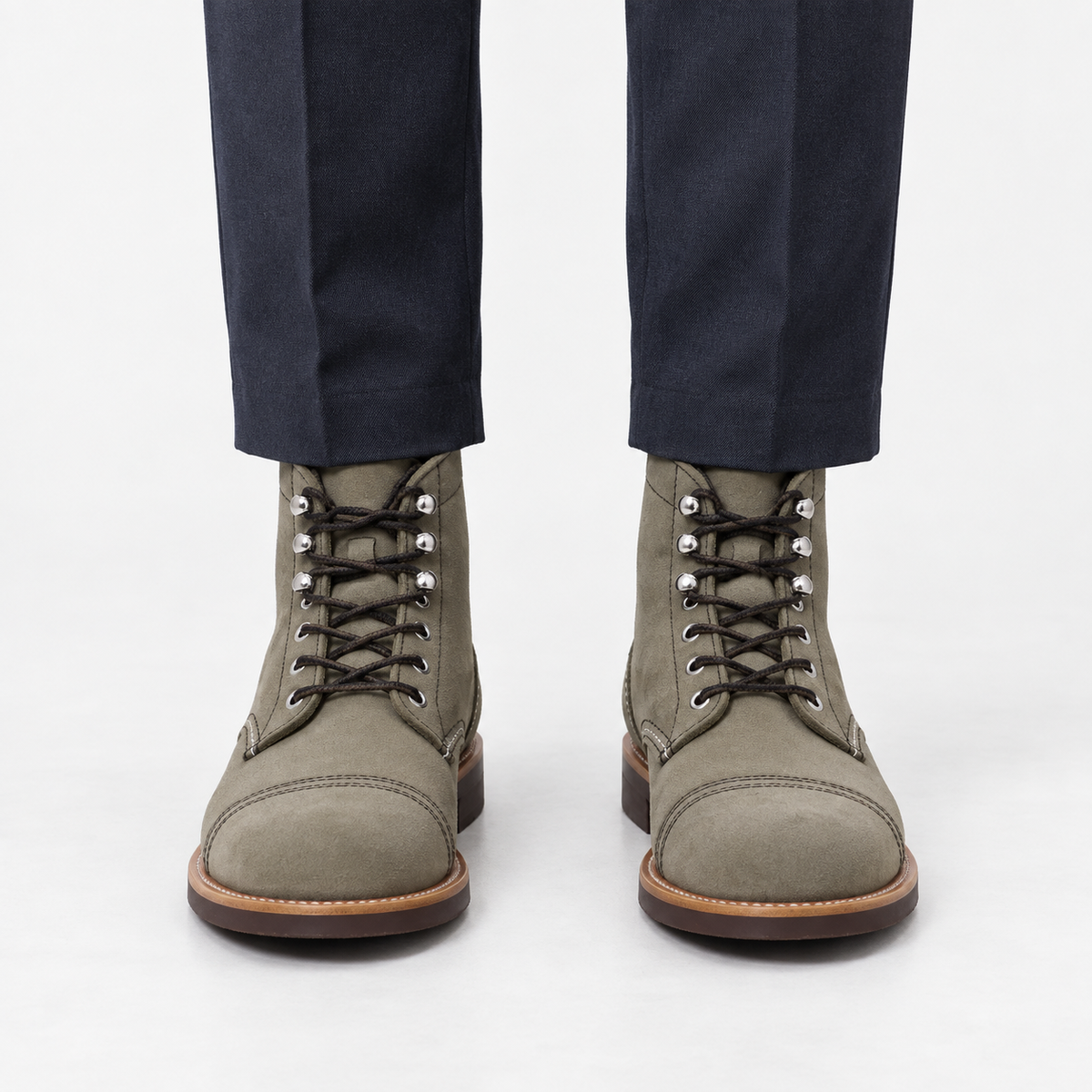 Leather cap toe lace up boots in gray suede, front view on a model