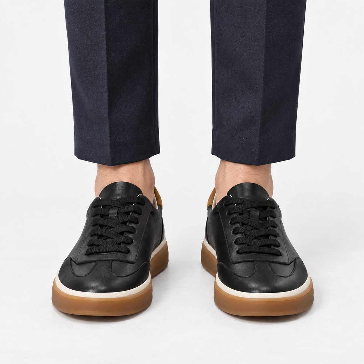 Leather court sneakers with gum soles in black, front view on a model