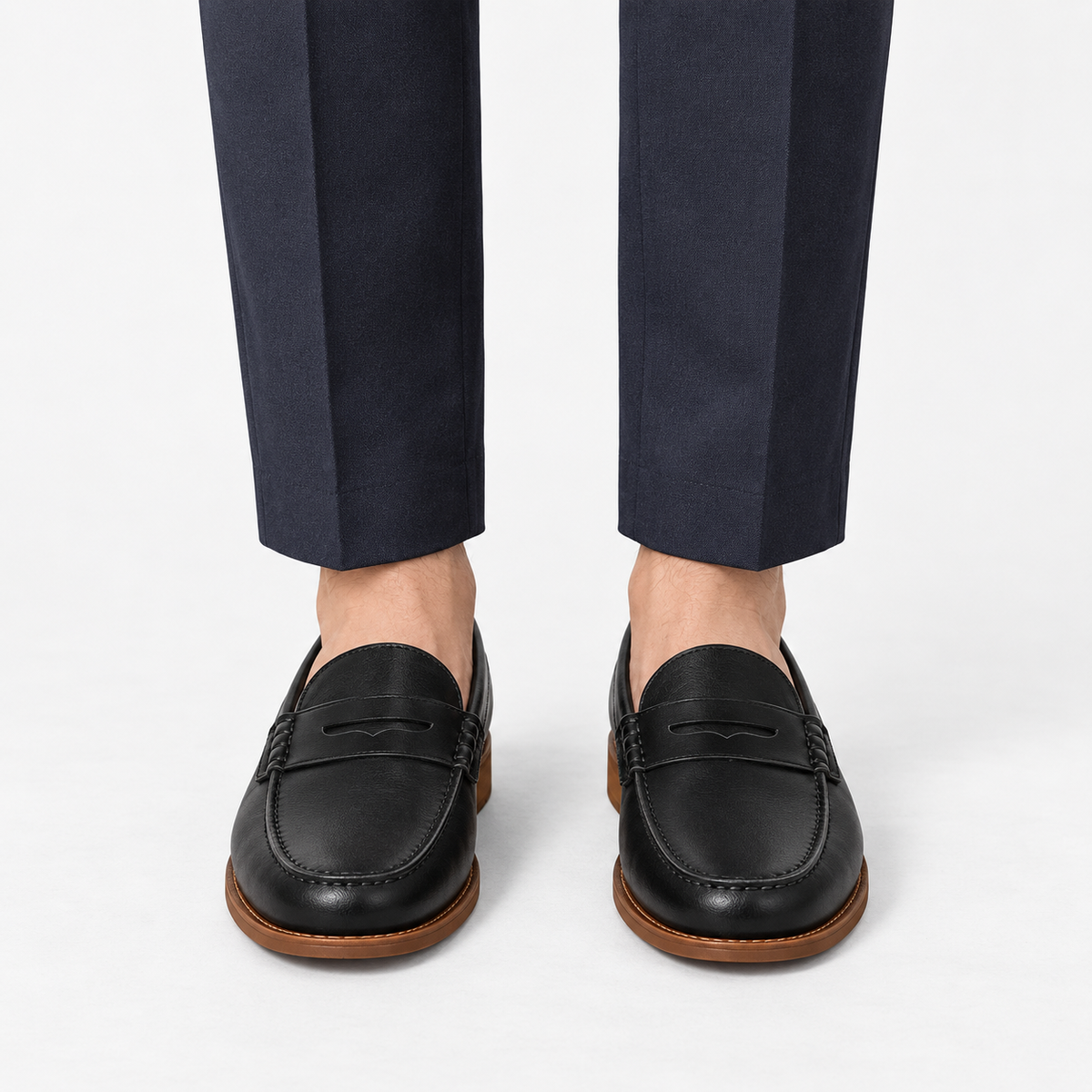 Leather penny loafers with contrast soles in black leather, front view on a model