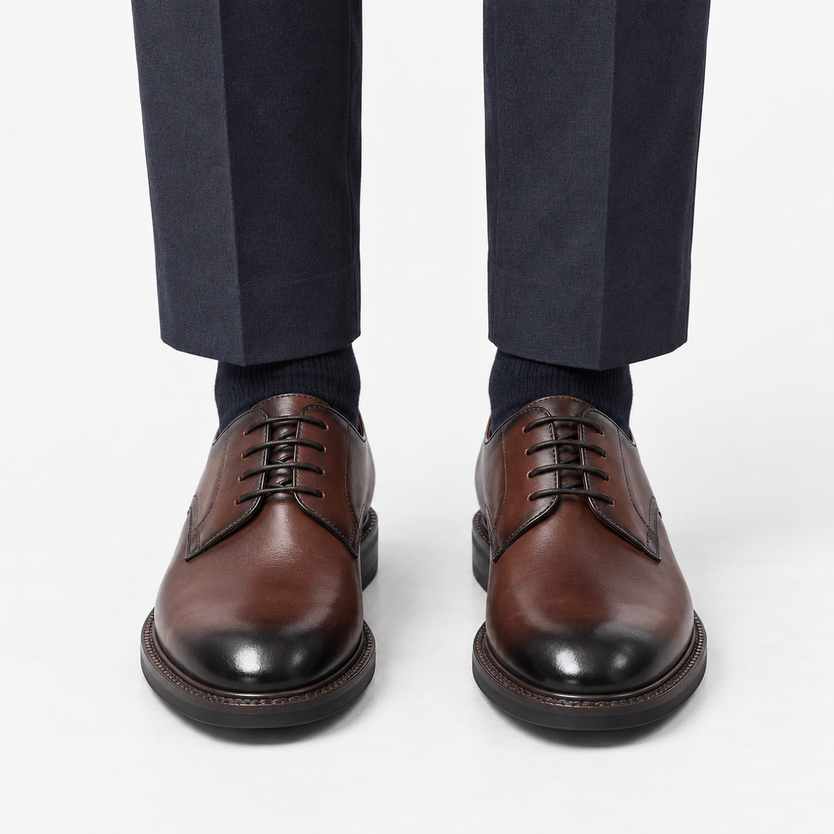 Leather plain toe derby shoes in brown, front view on a model