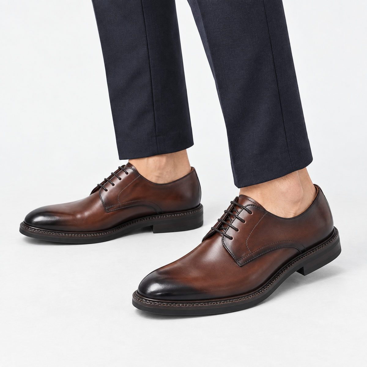 Leather plain toe derby shoes in brown, side view on a model