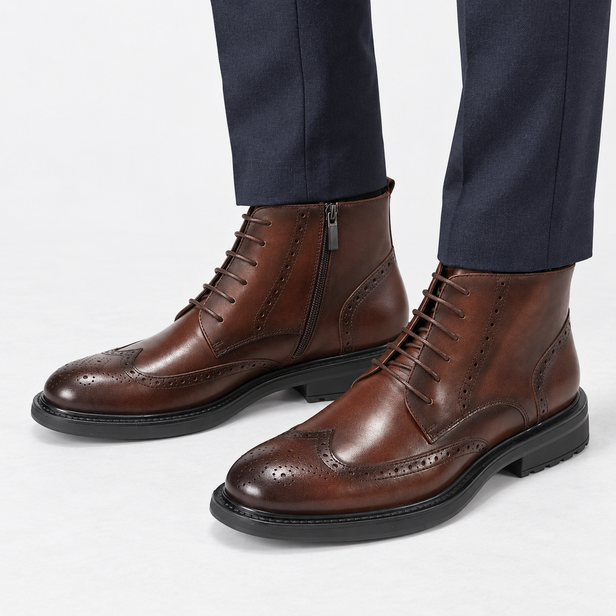 Leather wingtip boots with side zips in coffee, side view on a model