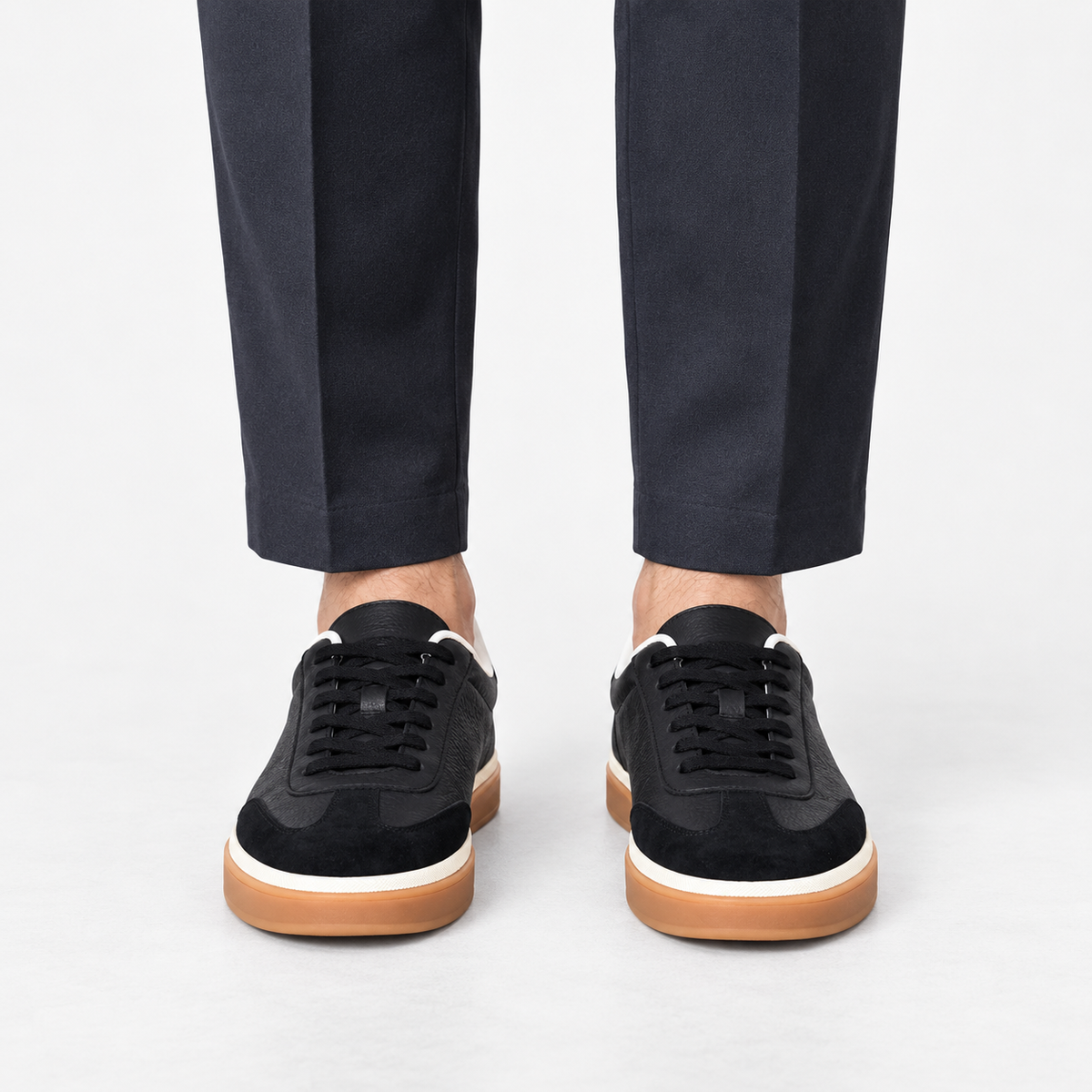 Retro leather sneakers with contrast soles in black gum sole, front view on a model