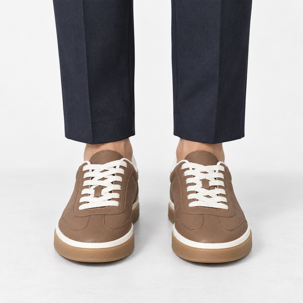 Retro leather sneakers with contrast soles in brown white sole, front view on a model